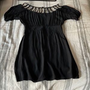 Black cocktail dress with shoulder detail